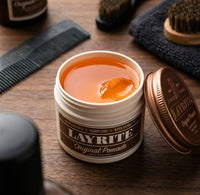 Layrite Original Pomade - open pot met oranje textuur bij kam en borstel
