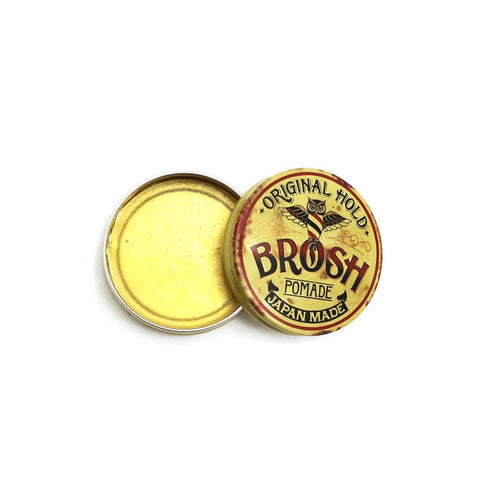 BROSH Original Pomade - open blik met gele inhoud, deksel schuin ertegenaan