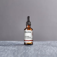 Bullfrog Secret Potion No. 2 Beard Oil - flesje op grijze textuur-ondergrond