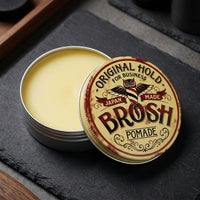 BROSH Original Pomade - open blik met gele pomade op leisteen, deksel rechtop